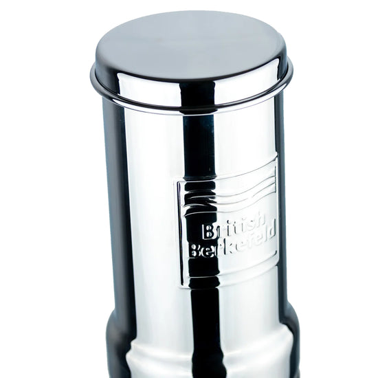 The American Reserves British Berkefeld 1 Liter Stainless Steel Gravity System boasts a sleek design with the brands name embossed on the side, using an Ultra Sterasyl ceramic filter for pure water through an efficient gravity-fed system.