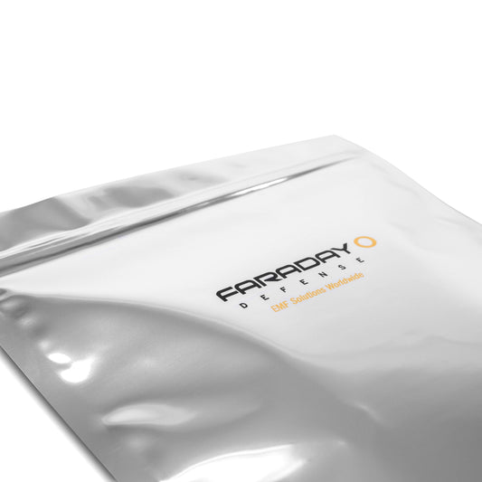 Silver Faraday Defense bag labeled American Reserves 7.0 Mil Faraday Cell Phone Bags (5 x 7, 5 pack) provides EMP protection and EMI attenuation against a plain background.