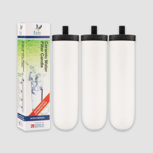 A set of three American Reserves British Berkefeld Doulton Ultra Sterasyl 7 ceramic replacement candles for gravity drinking water systems is placed next to their packaging box, displaying the text and logo.