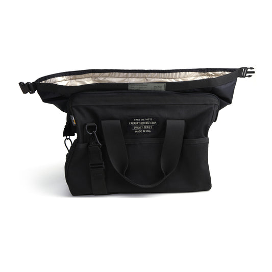 The American Reserves CORDURA® Utility Bag Medium features two top handles and an adjustable shoulder strap. It opens to reveal a silver, signal-blocking interior, ideal as a Faraday pouch. A label adorns the front.