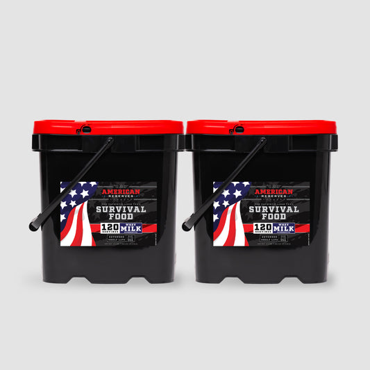 The American Reserves 240 Servings Milk Bundle includes two black buckets with red lids, featuring Survival Food labels and an American flag design, ensuring a long-term shelf life. Together, they offer 240 servings of powdered whey milk, creating a lasting sense of security on a gray background.