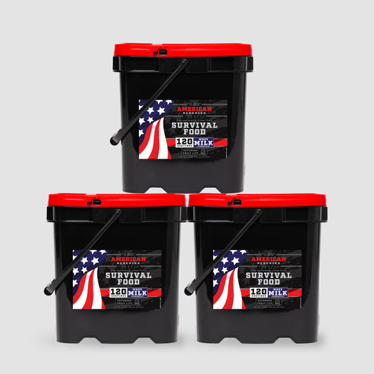 Three black buckets with red lids from American Reserves form a pyramid with an American flag design. Labeled 360 Servings Milk Bundle, each bucket contains 120 servings of powdered whey milk and features a 25-year shelf life, set against a plain gray backdrop to highlight their durability.