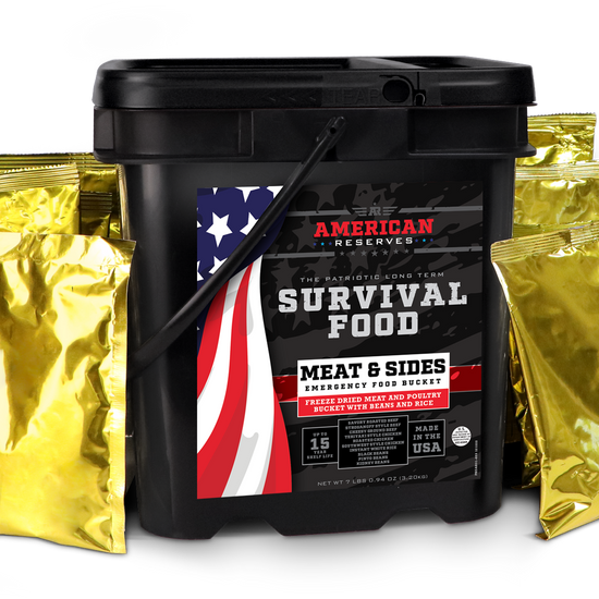The American Reserves 110 Serving Freeze Dried Meat & Sides Bucket is black with an American flag design and includes six shiny gold foil pouches. This emergency food storage option emphasizes the importance of long-term shelf life with freeze-dried meat.