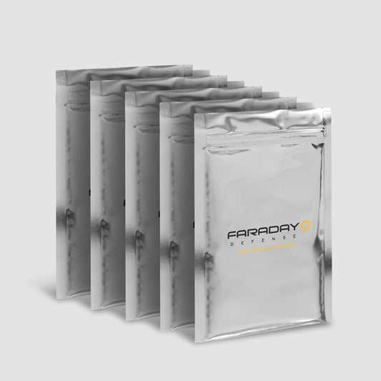 Five metallic, rectangular Faraday bags, labeled American Reserves, designed for EMP protection and EMI attenuation, are arranged in a staggered row against a gray background. These are the 7.0 Mil Faraday Cell Phone Bags, measuring 5 x 7, available in a pack of five.