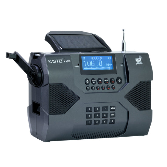 The Kaito Emergency Radio Voyager Max KA900 from American Reserves is ideal for emergency preparedness. It features a digital display at 106.8 MHz, solar panel, hand crank, speakers, numeric keypad, and NOAA logo for weather alerts with Bluetooth, an MP3 player, and a phone charger.
