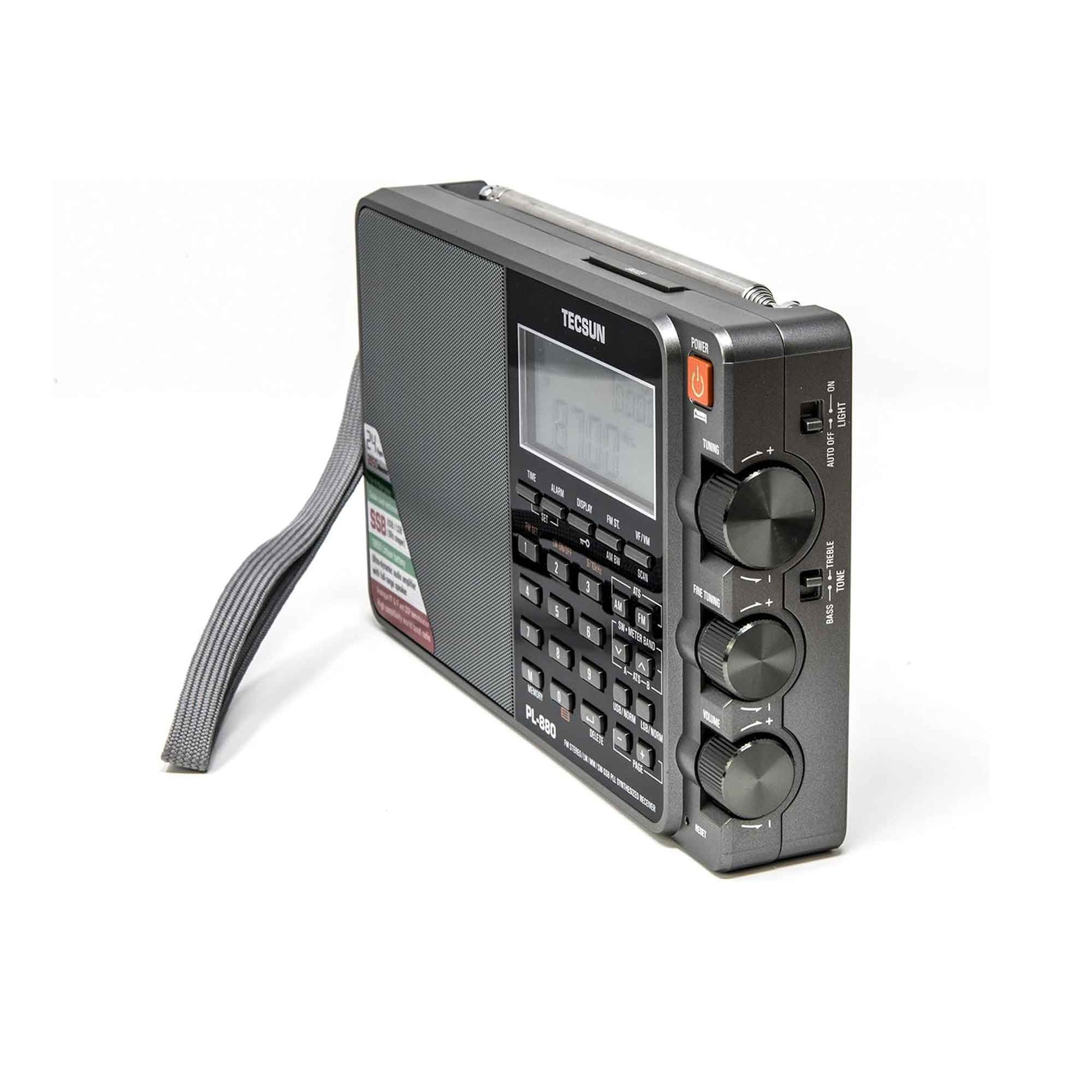 The Tecsun PL880 by American Reserves is a portable radio with a PLL dual conversion world band receiver, SSB support, dynamic audio amplifier, handle, digital display, numeric keypad, tuning knobs, and boasts a rechargeable battery. It comes with a leather pouch and is shown from an angled side view.