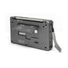 Rear view of the Tecsun PL880 by American Reserves shows a folded telescopic antenna, battery compartment for rechargeable batteries, input/output ports, and a wrist strap.