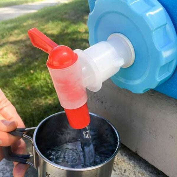 Water from a blue AquaBrick 2 Pack Food and Water Storage Container by American Reserves, featuring a red and white spout, flows gracefully into a metal cup.