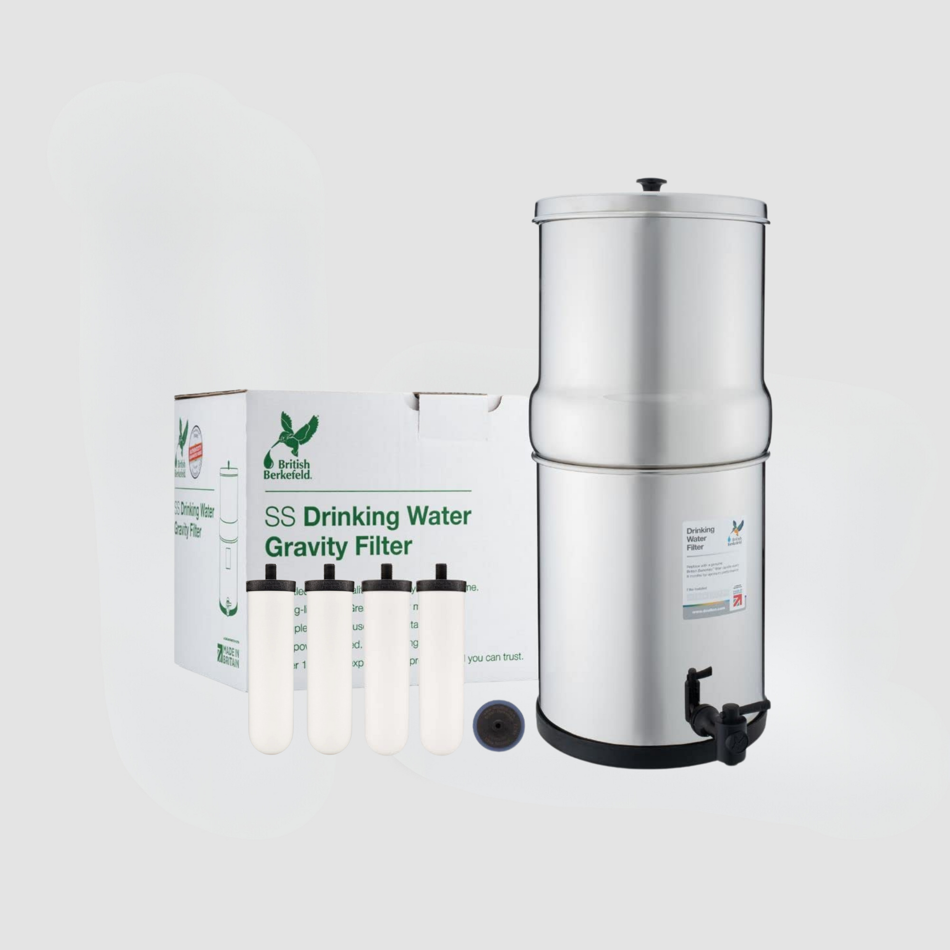 The American Reserves British Berkefeld Doulton 2.25 Gallon Countertop Gravity-Fed Water Filtration System includes four Ultra Sterasyl ceramic filter candles, a black spigot, and is labeled SS Drinking Water Gravity Filter, reflecting the renowned design and quality.