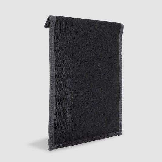The CORDURA® Berry Compliant Faraday Tablet Jacket by American Reserves is a black, rectangular fabric wallet with a folded top edge and stitched borders, displayed vertically against a light background, highlighting its durable design.