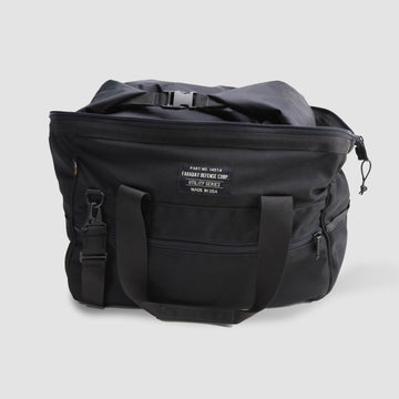 The American Reserves CORDURA® Utility Bag Large, black with two handles, a front pocket, and a zipper top, features a label stating Faraday Defense Corp Utility Series Made in USA and provides reliable signal blocking for optimal security.