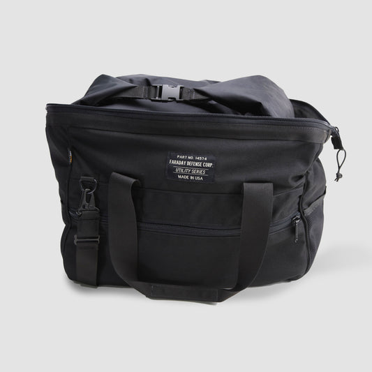 The American Reserves CORDURA® Utility Bag Large, black with two handles, a front pocket, and a zipper top, features a label stating Faraday Defense Corp Utility Series Made in USA and provides reliable signal blocking for optimal security.