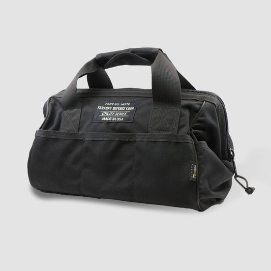 The CORDURA® Utility Bag Small by American Reserves is a black duffle featuring two handles, front pockets, and a label with text.