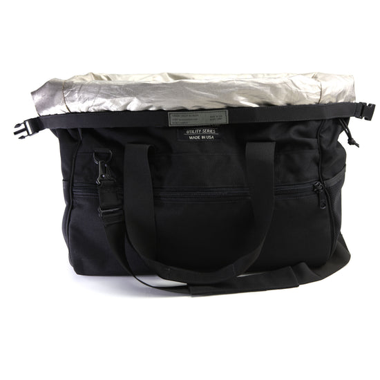 The American Reserves CORDURA® Utility Bag Large, made in the U.S.A., is a black utility bag with multiple compartments and straps. It features a metallic top flap and signal-blocking technology to protect your electronics on the go.