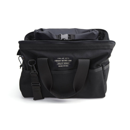 The medium black CORDURA® Utility Bag by American Reserves features dual handles, a front label saying Faraday Defense Corp, Utility Series, Made in USA, and a partially visible interior. This versatile pouch ensures signal blocking for enhanced security.