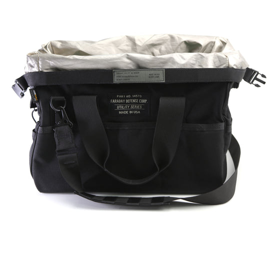The Black and Gray CORDURA® Utility Bag Medium from American Reserves features multiple pockets, an adjustable shoulder strap, and a front label. It now also includes a Faraday pouch for enhanced signal-blocking protection.
