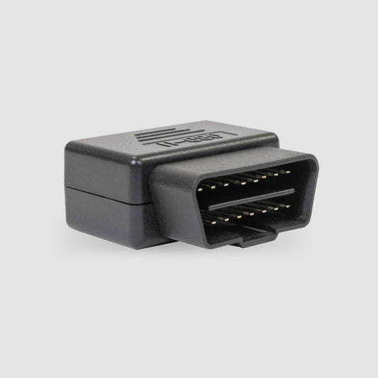 Against a plain background rests a black OBD2 diagnostic connector with visible metal pins. Engineered by American Reserves, it features transient voltage suppression for effective EMP Vehicle Protection.