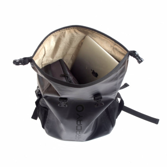 The American Reserves Faraday Dry Bag Backpack in Stealth Black reveals a beige interior lining, safely holding a laptop and smartphone. It delivers EMP protection, ensuring devices stay shielded from unforeseen interferences while on the move.