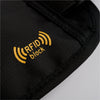 Close-up of a black fabric on the American Reserves Faraday Waist Pack – RFID Belt Bag, showcasing a yellow RFID block logo indicating radio frequency identification protection.
