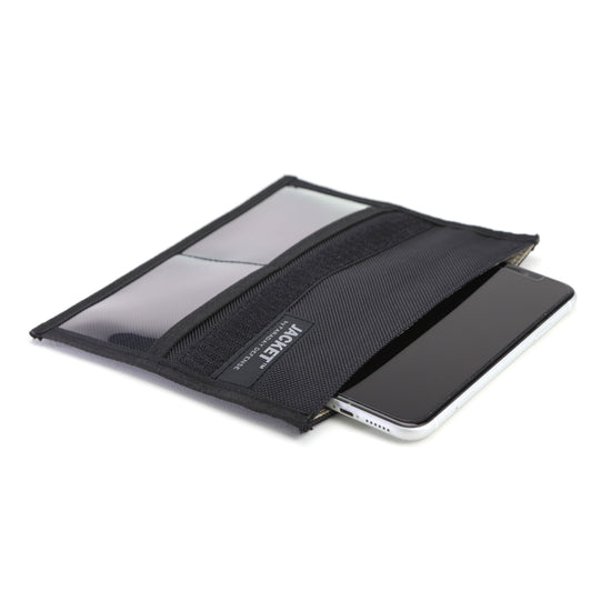 An XL Forensic Faraday Jacket Kit by American Reserves reveals a smartphone partially sliding out of its black fabric pouch, which features a mesh flap and transparent panel for effective signal blocking and enhanced EMF protection.