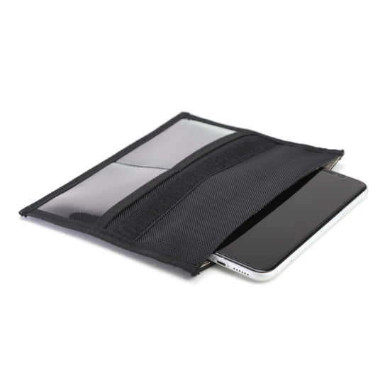 A black pouch with a smartphones edge visible, this ultimate shielding solution acts as the American Reserves XXL Forensic Faraday Jacket Kit for device protection and signal blocking.