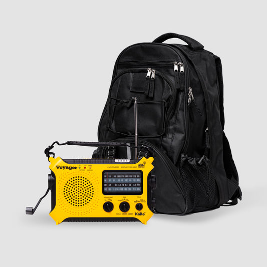A black American Reserves survival backpack stands beside a yellow Kaito KA500 crank radio with its antenna extended, set against a plain gray background.