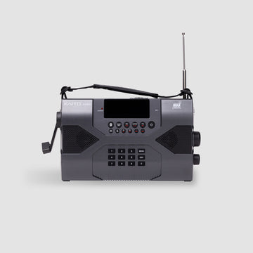 The American Reserves KA900 Voyager Max is a sleek, black receiver with a rectangular shape, digital display, buttons, and a smooth hand crank. Its telescopic antenna extends upward for emergency preparedness, ensuring connectivity.