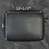 The American Reserves PU Leather Large Privacy Protection Laptop Sleeve rests on a dark gray marble surface. Measuring 9 x 13.5, this black sleeve enhances privacy with its elegant design and discreetly fits into any setting.