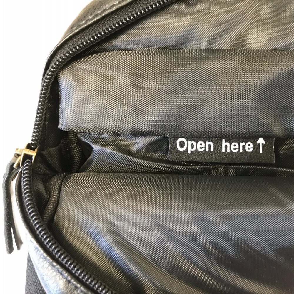 Close-up of a PU Leather Large Privacy Protection Laptop Sleeve (9 x 13.5) by American Reserves, featuring a partially open zipper and a label reading Open here with an upward arrow.