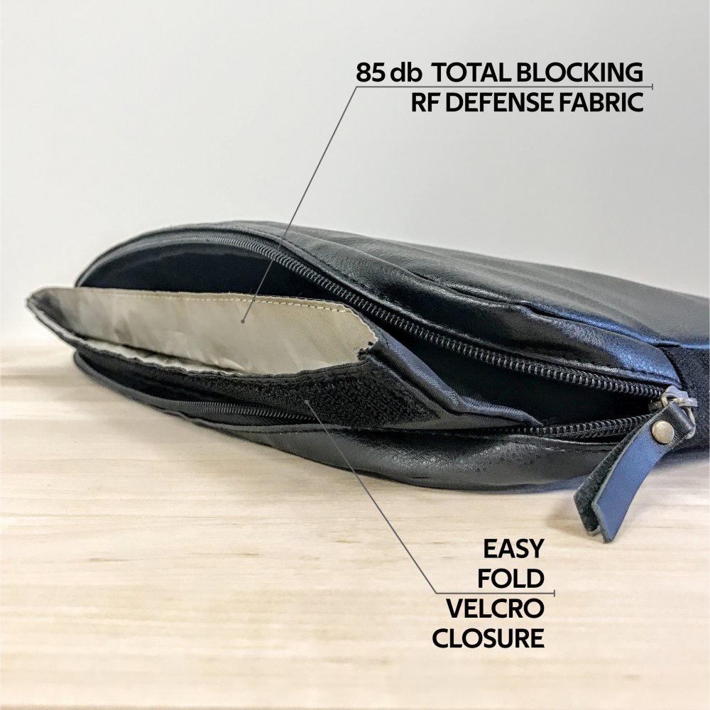 The American Reserves PU Leather Large Privacy Protection Laptop Sleeve (9 x 13.5) in sleek black offers anti-tracking protection with total RF blocking technology. It features a zip and Easy Fold Velcro Closure, ideal as a stylish privacy bag on any wooden surface.