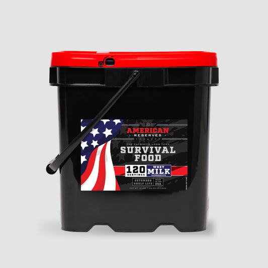The American Reserves 120 Servings Emergency Whey Milk Alternative comes in a black bucket with a red lid and American flag design, featuring a sturdy black handle. The product, made in the USA, is set against a plain gray background and offers long-term shelf life.