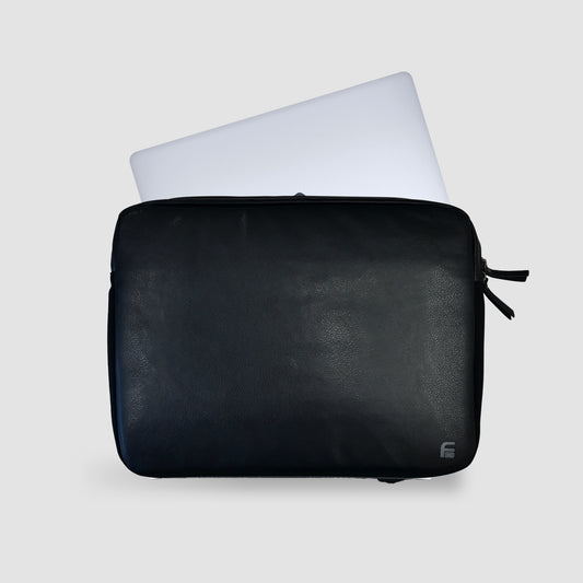 A PU Leather Large Privacy Protection Laptop Sleeve by American Reserves, in black, enhances security with signal blocking while partially holding a light-colored laptop against a gray background.