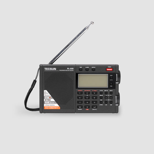 The American Reserves Tecsun PL330 Portable AM FM Shortwave PLL DSP Radio with SSB and Synchronous features a digital display, control buttons, extended antenna, and a carrying strap on a light gray background.