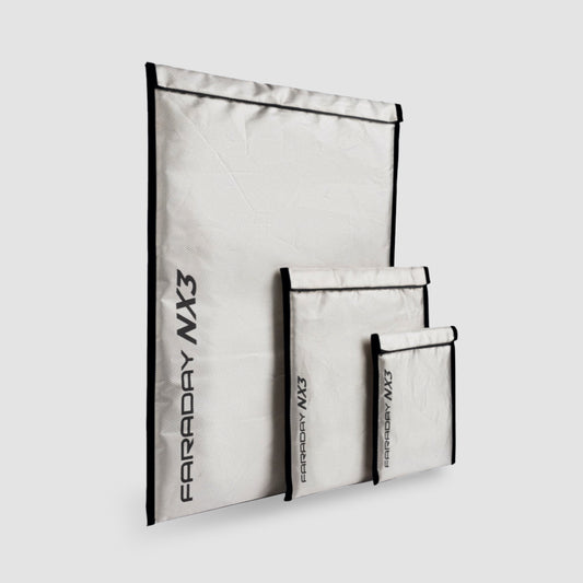 The Triple Layer CYBER Fabric Faraday Bags Kit (3 pack small) by American Reserves includes three signal-blocking, EMF-protective white bags with black text and borders, elegantly showcased against a gray background.