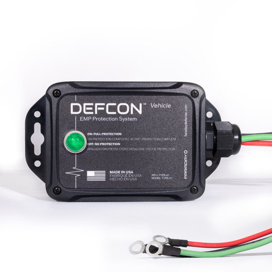 The Complete Auto And Home Protection EMP Kit by American Reserves is a black box with a green indicator light, three metal-looped wires, and text on its function and origin, offering robust defense against electromagnetic pulses for vehicles and homes.