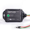 The Complete Auto And Home Protection EMP Kit by American Reserves is a black box with a green indicator light, three metal-looped wires, and text on its function and origin, offering robust defense against electromagnetic pulses for vehicles and homes.