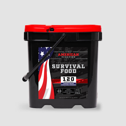 The American Reserves 120 Serving Freeze Dried Vegetable Bucket comes in a black container with a red lid featuring an American flag design and offers a 25-year shelf life, perfect for emergency supply meals.